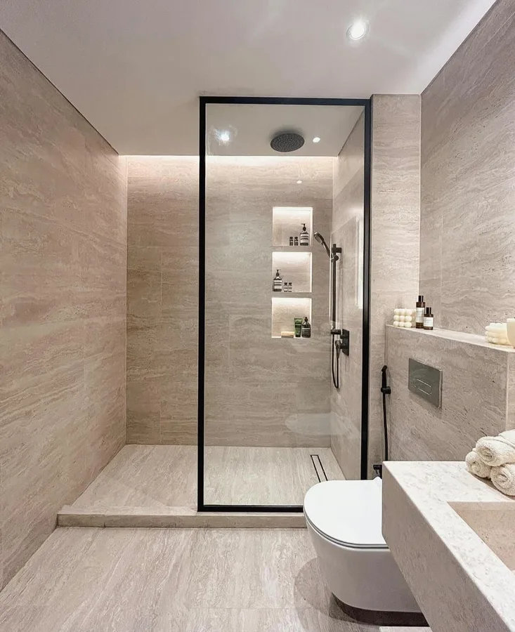 Walk-in glass shower enclosure with slim black aluminium framing