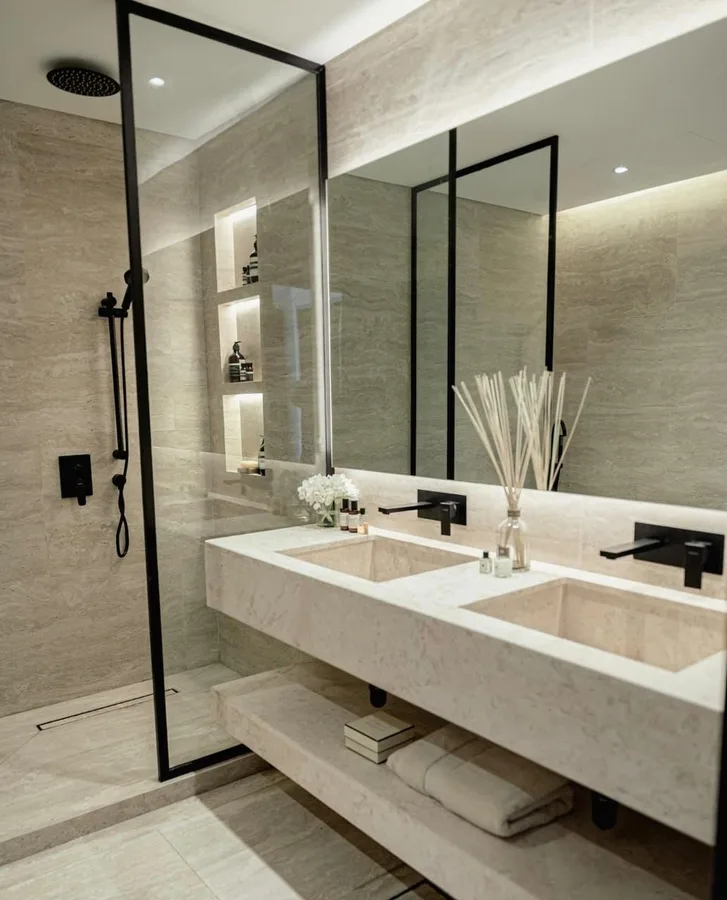 Two black framed mirrors above a stone double vanity